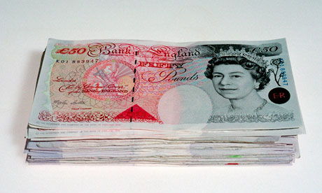 Pile of British bank notes.