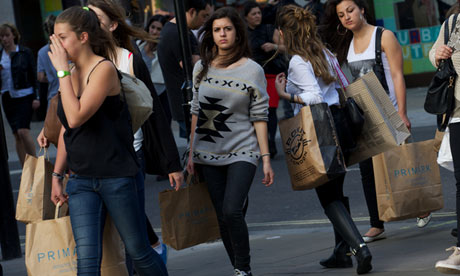 Shoppers carry their purchases as they w