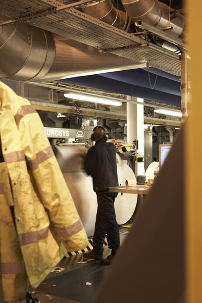 A Guardian Print Centre employee preparing a paper reel