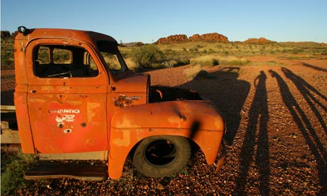 Sunset over an old vehicle near Glen Helen Gorge in Australia