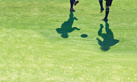 Two men training on a football pitch