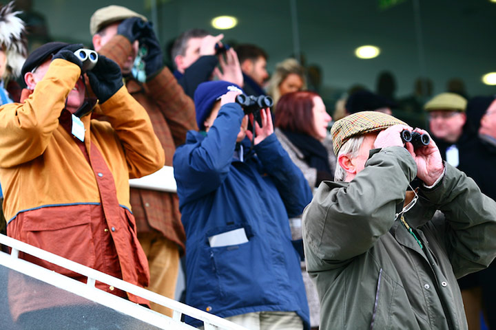 Spectators catch the action though their binoculars