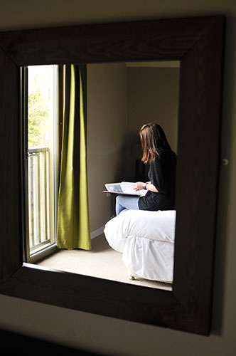 Bluestone: A guest sits on a bed at Bluestone