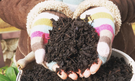 Woman holding a handful of compost