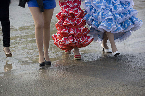 Photography masterclass: Shot of four woman's feet as they walk across a damp pavement