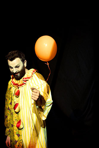Portraiture masterclass: A clown from the Fire Tusk Pain Proof Circus holding a balloon