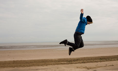 A man jumping on Brighton beach