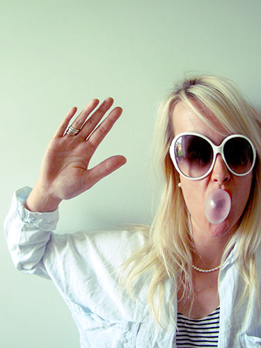 Portrait: A girl blowing a bubble with bubblegum