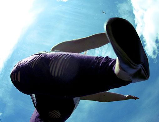 Movement: A woman jumping, photographed from below. 