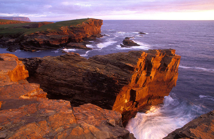 Visit Orkney: The cliffs of Yesnaby on the west coast of Orkney Mainland at sunset.