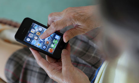 An elderly old woman uses her iPhone 