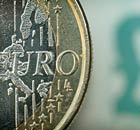 A one euro coin alongside a British pound ensignia