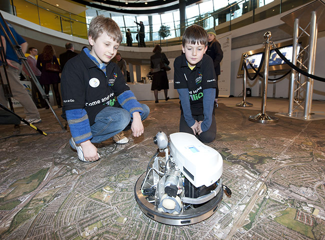 WorldSkills 2011: Two boys play with a robot at the WorldSkills 2011 launch