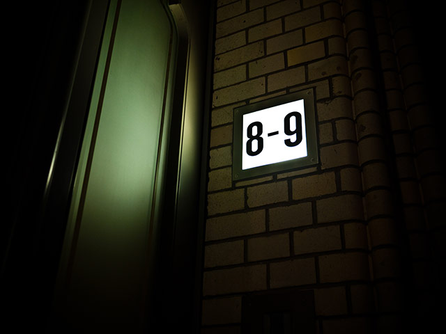 Berlin Panasonic: Number eight and nine lit up on a Berlin apartment building