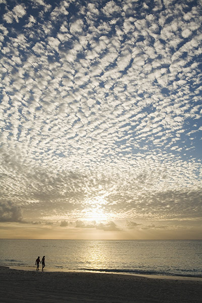 Cayman Islands Romance: Couple Walking on beach at sunset