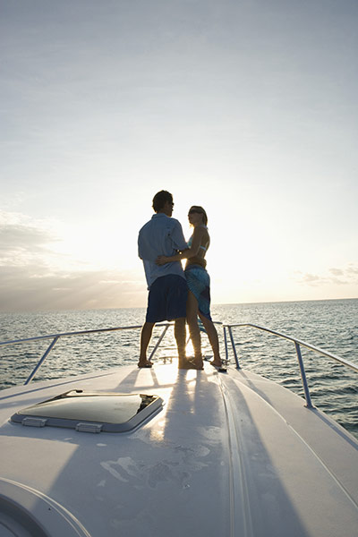 Cayman Islands Romance: Couple on Boat at Sunset