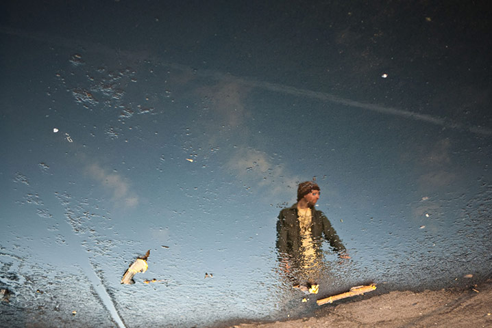 Panasonic rooftop rider: A rooftop biker reflected in a puddle