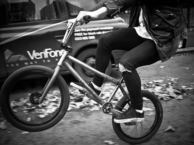 Panasonic rooftop rider: A biker pops a wheelie on a bike