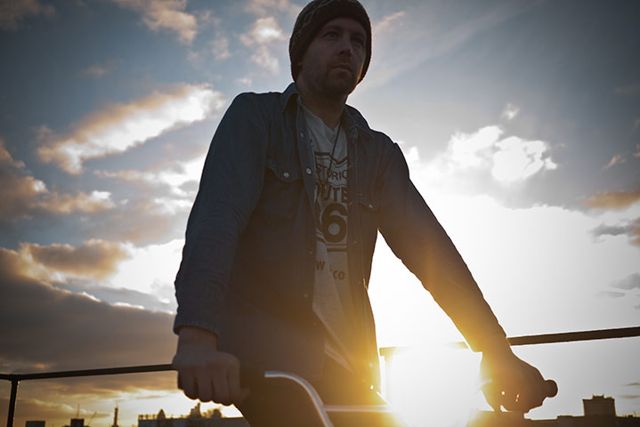 Panasonic rooftop rider: A burst of sunshine behind a a man on a bike