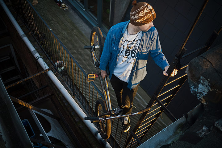Panasonic rooftop rider: Biker climbing the fire escape with a bike