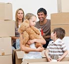 Family unpacking boxes after move in