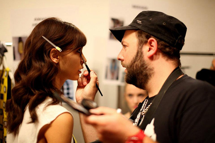 MB | Gallery: A makeup artist applies makeup to a model's face