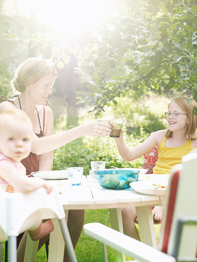 Brita drinks: Mother with two daughters relaxing in garden