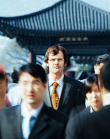 Businessman in crowd, portrait (Focus on businessman)