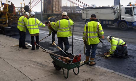 Workers repairing the road surface with tarmac, Glasgow, Scotland,UK, Great Britain