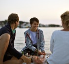 Sweden: friends sharing a drink by the water, Sweden