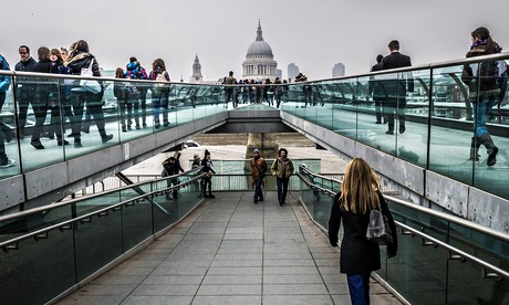 People walking over Millenium Bridge, London