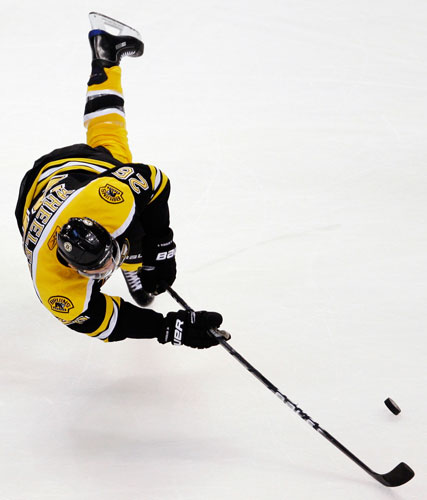 24sport: Boston Bruins Blake Wheeler goes airborne as he tries to control the puck