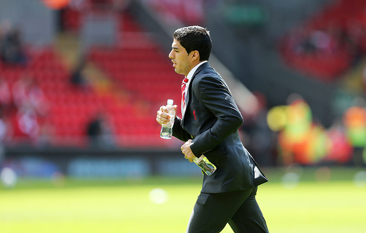 Liverpool v Everton: Liverpool's Luis Suarez runs back from the dressing room across the pitch b