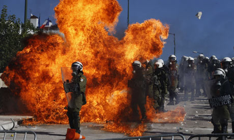Demonstrators clash with riot police in front of the Greek parliament in Athens