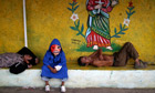 A child dressed as a devil sits between two inebriated men during a celebration in Nicaragua