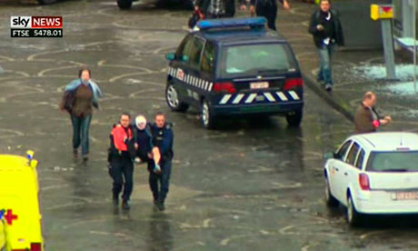 An injured person is carried after a grenade attack in Liege, Belgium