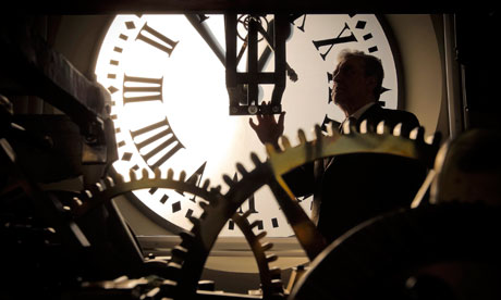 A clockmaker checks and adjusts the Madrid New Year clock