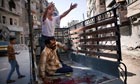 An injured man arrives at the Dar al Shifa hospital in Aleppo, Syria