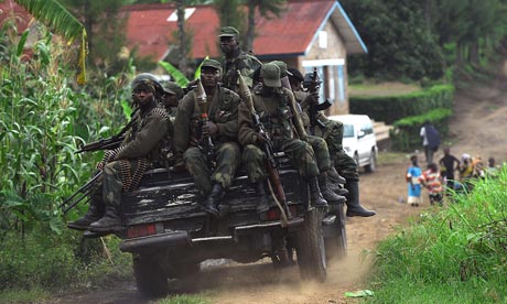 Democratic Republic of the Congo government soldiers ride on the back of a truck, in Minova