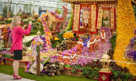 A visitor photographs the Thai exhibit in the Great Pavilion, at the RHS Chelsea Flower Show