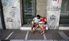 A family beg on the street in Athens, Greece, June 13