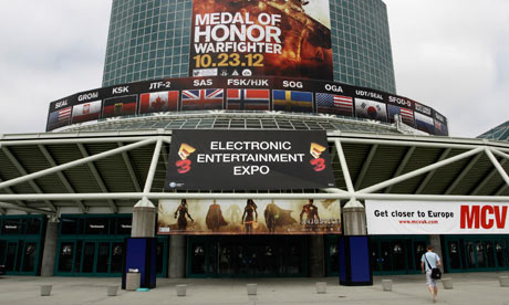 A man walks past signs in place for E3 2012 at the Los Angeles Convention Center