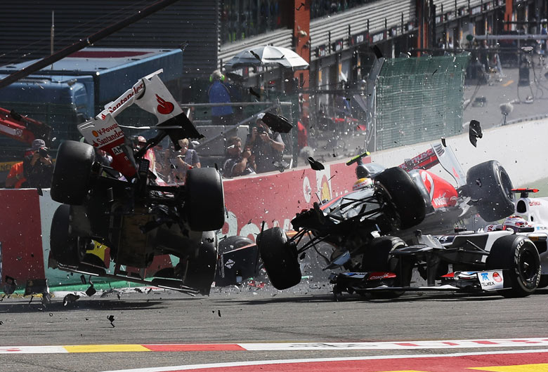 Fernando Alonso, left, and Lewis Hamilton collide at the Belgian Grand Prix
