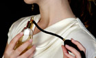 Woman applying perfume