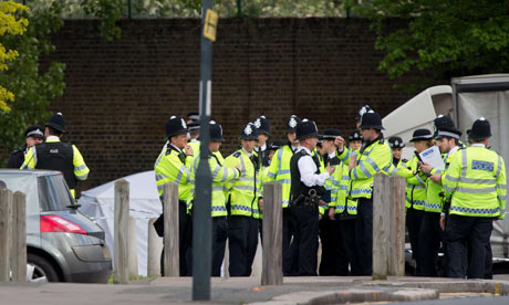 Police officers man a cordoned off area in Woolwich