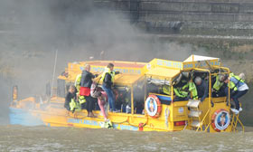 A Duck Tour boat catches fire on the River Thames in London