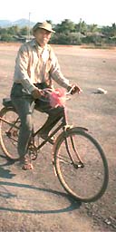 Villager cycling in Laos