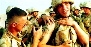 A member of B Company of the Royal Scots, on duty in Saudi Arabia in 1991, receives an injection against the effects of a possible chemical attack