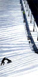 A man struggles with a pushchair after heavy snow in Belfast