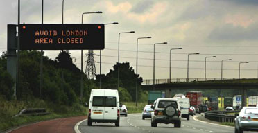 Southbound traffic passes a sign on the M6 motorway advising motorists to avoid London following a series of explosions targeting the capital's underground and bus networks. Photograph: Daniel Berehulak/Getty Images